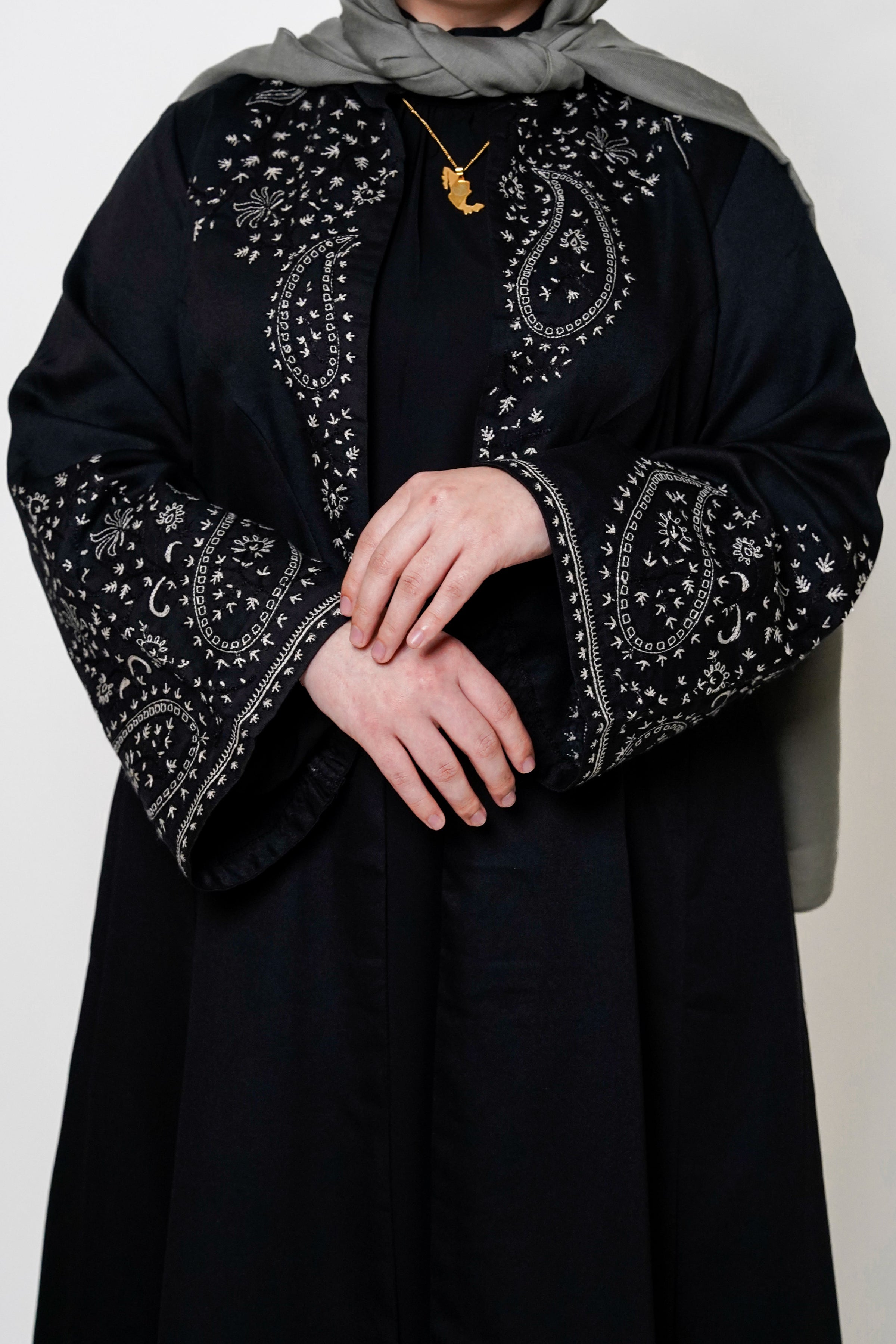 Black & White Embroidered Open Abaya close up featuring intricate black and white embroidery on a classic open design, offering a timeless and luxurious look. Perfect for both formal and casual outfits.