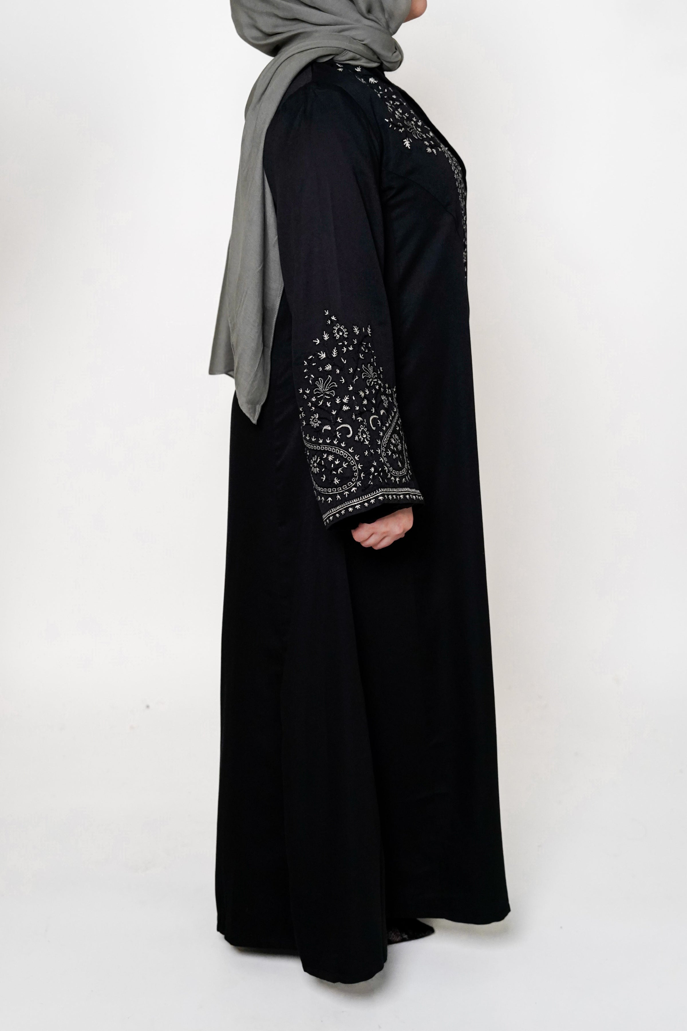 Black & White Embroidered Open Abaya featuring intricate black and white embroidery on a classic open design, offering a timeless and luxurious look. Perfect for both formal and casual outfits.