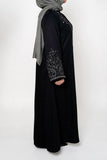 Black & White Embroidered Open Abaya featuring intricate black and white embroidery on a classic open design, offering a timeless and luxurious look. Perfect for both formal and casual outfits.