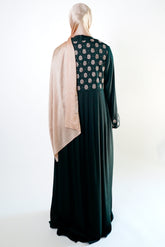 an elegant emerald green kimono with intricate floral embroidery on the back. The kimono has long sleeves.