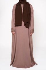 Back view of a brown abaya with intricate embroidery on the buttons, back, and sleeve ends, offering sophistication and exclusivity. A timeless piece perfect for both dinner parties and masjid visits, combining style and comfort.