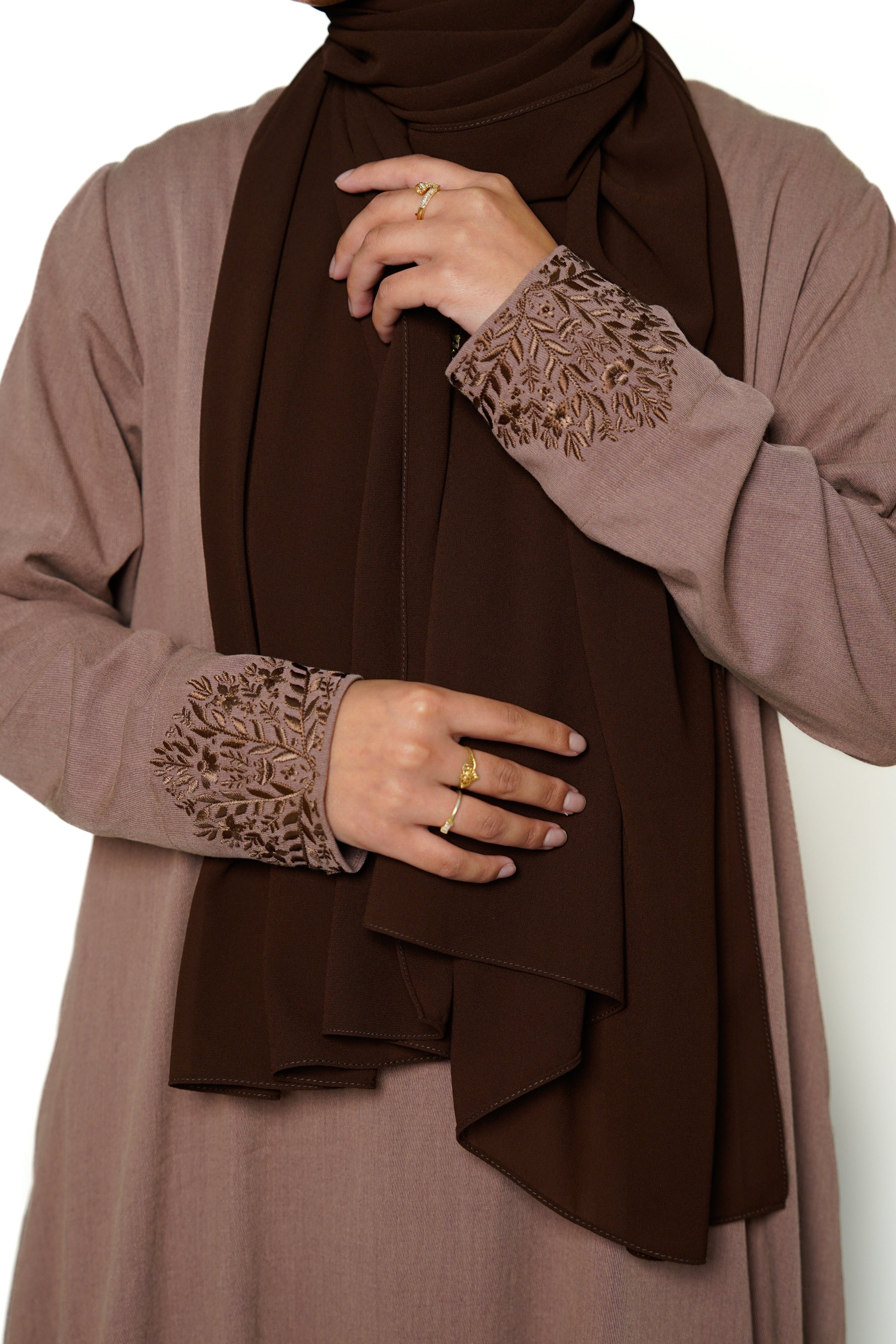 Heather Sand Button Back Embroidered Abaya Close-up of the brown abaya featuring intricate embroidery on the sleeves, showcasing its sophisticated design. This timeless piece combines elegance and comfort, perfect for both dinner parties and masjid visits