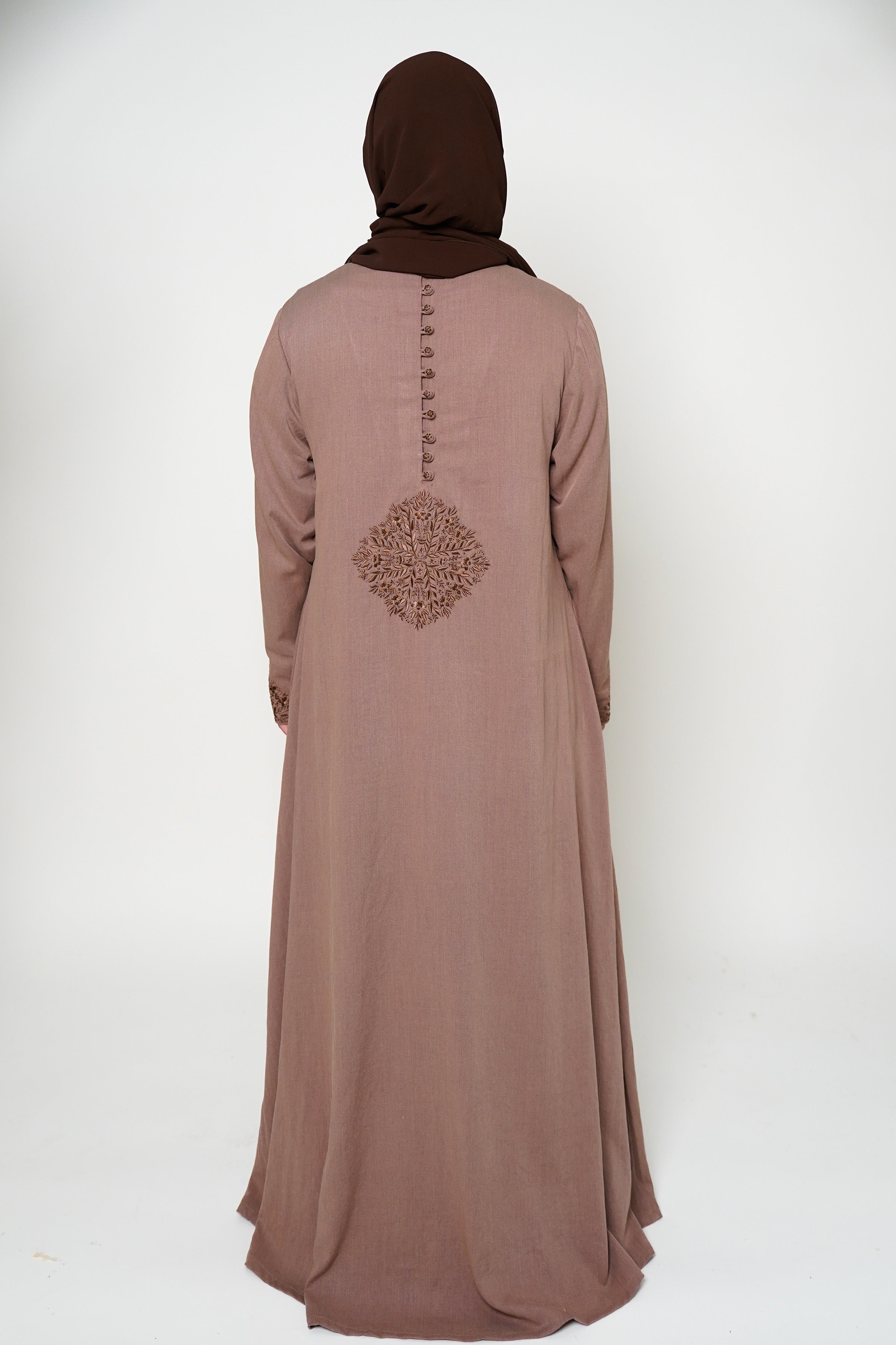 Back view of a brown abaya with intricate embroidery on the buttons, back, and sleeve ends, offering sophistication and exclusivity. A timeless piece perfect for both dinner parties and masjid visits, combining style and comfort.