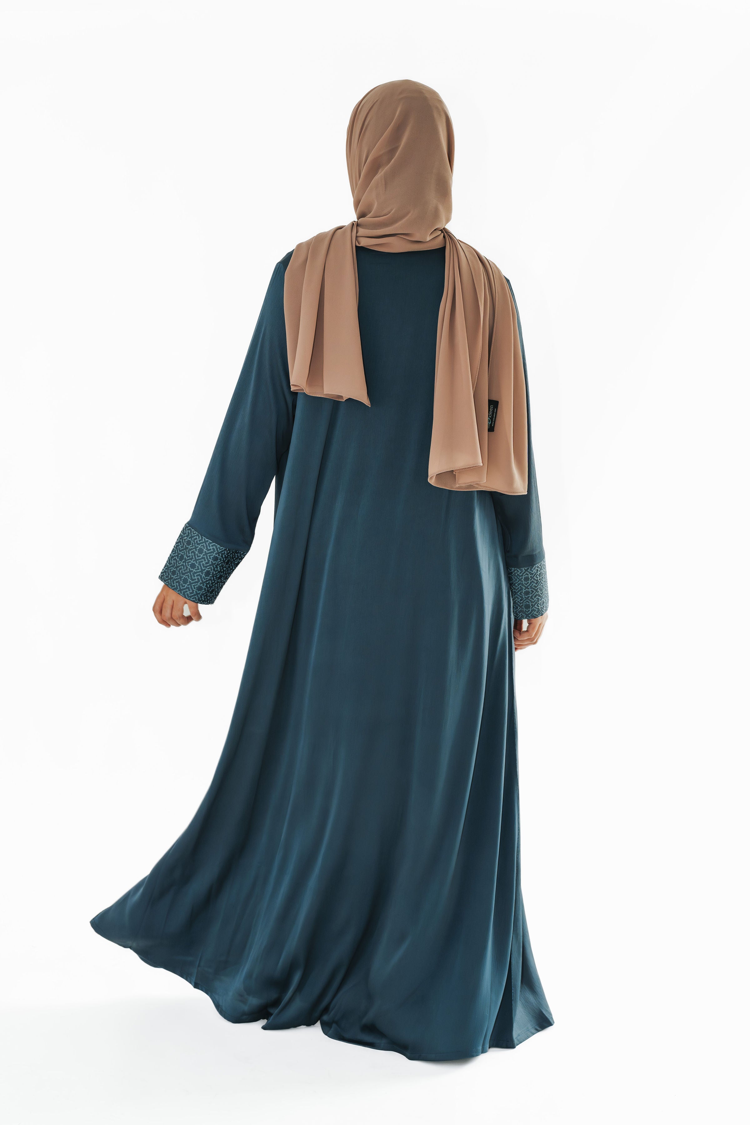 Close-up of the slate blue open abaya, highlighting the embroidered geometric print on the cuffs, adding sophistication and elevating modest style with an exclusive design.