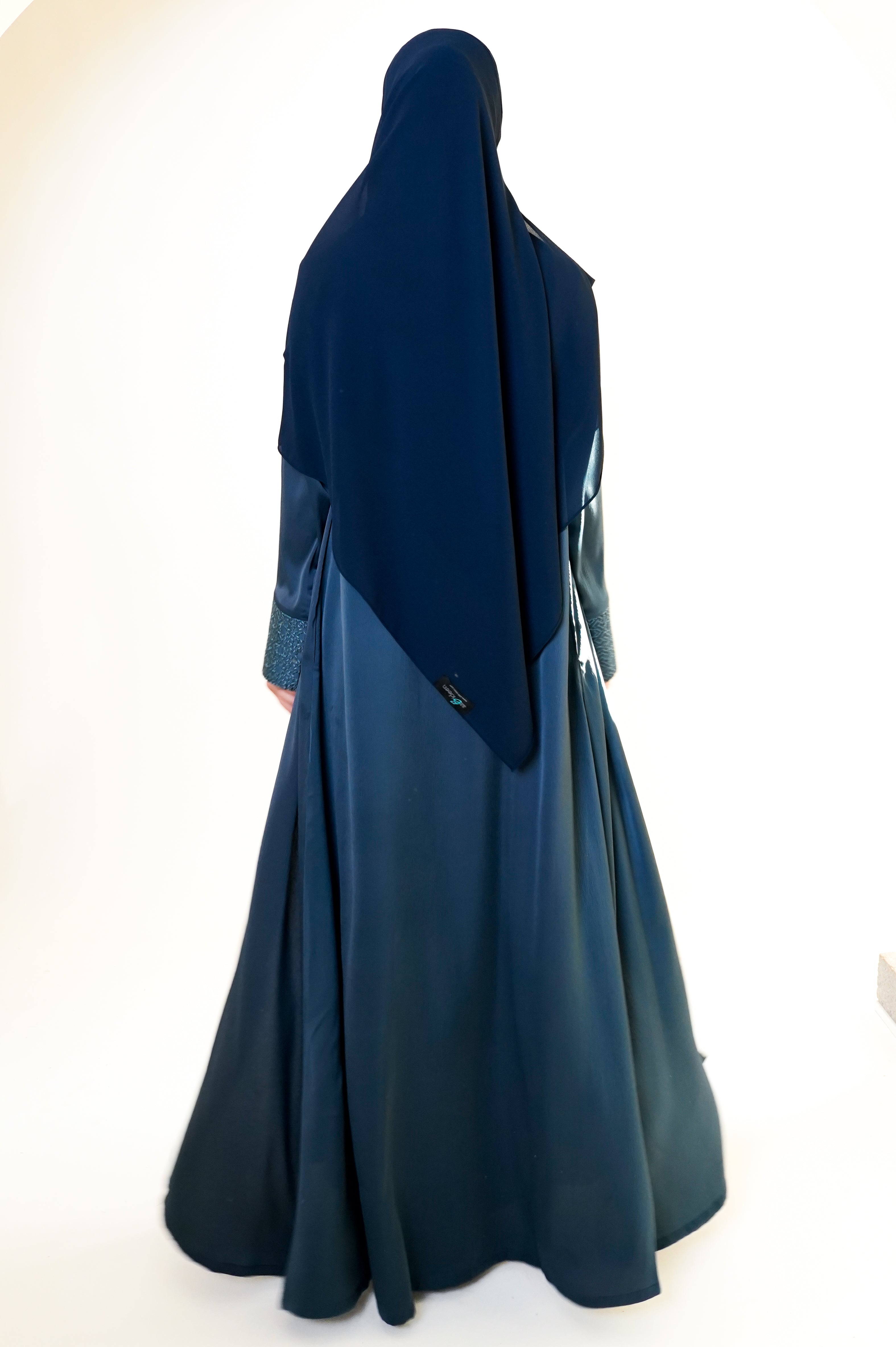 Slate blue open abaya with geometric embroidered cuffs, offering a sophisticated and exclusive design that elevates modest style