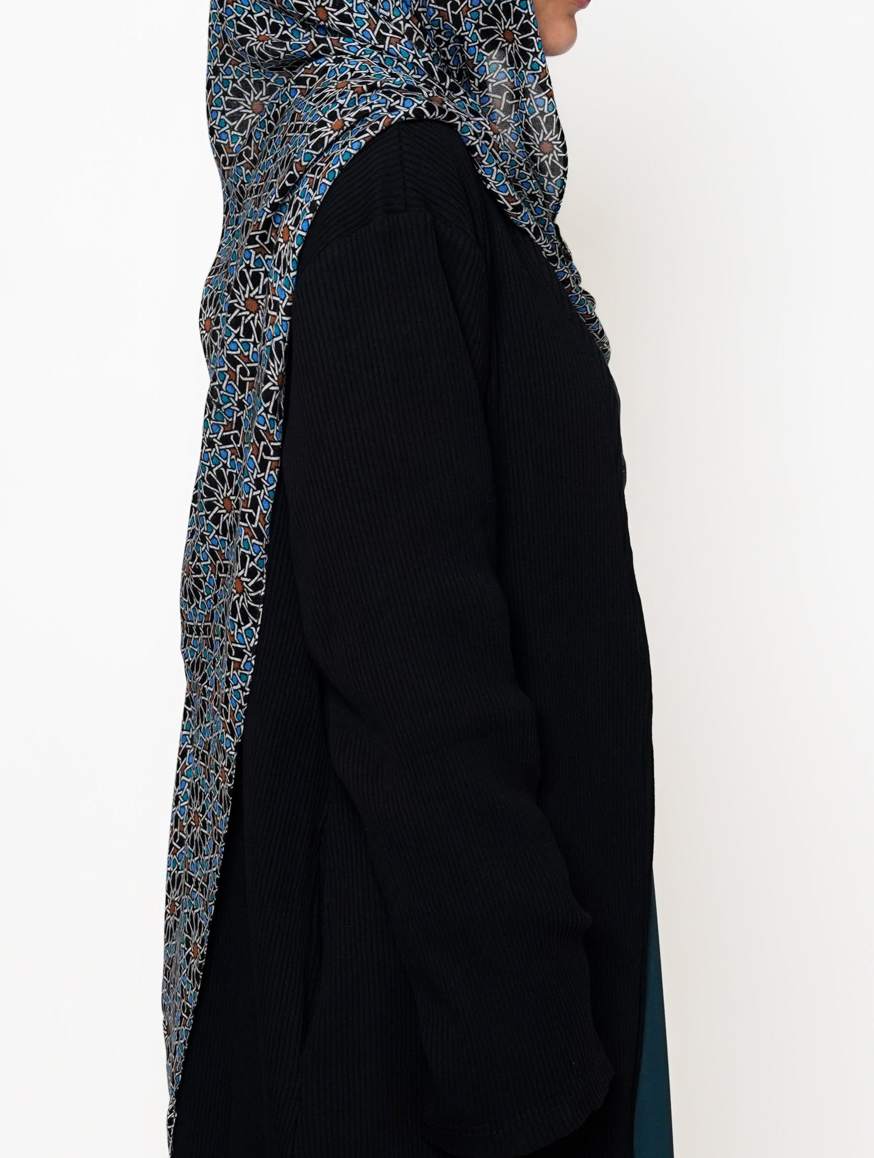 Fezaic Bamboo Modal Hijab featuring a mosaic tile print inspired by the colors of Morocco, with intricate patterns in blue, black, and earthy tones.