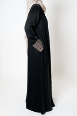 Black crepe open abaya featuring a geometric embroidered print on the cuffs, offering sophistication and elevating modest style with an exclusive design