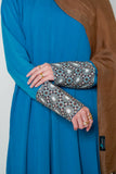 Close-up of the Luxury Caspian Blue Embroidered Cuff Abaya, showcasing intricate cuff embroidery in vibrant blue and gold. The abaya is made from soft fabric with panels for a full, flowing design, offering both comfort and sophistication.