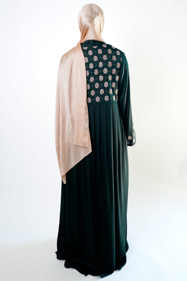 an elegant emerald green kimono with intricate floral embroidery on the back. The kimono has long sleeves.