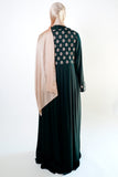 an elegant emerald green kimono with intricate floral embroidery on the back. The kimono has long sleeves.