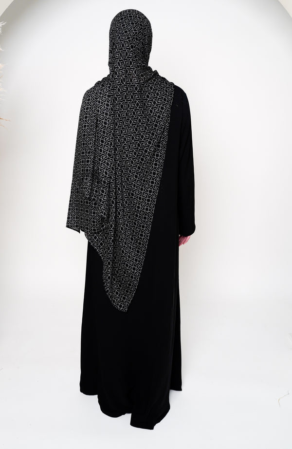 Geo Black Bamboo Modal Hijab in black featuring a modern geometric pattern in white, offering a sleek and stylish design that blends elegance with contemporary appeal.