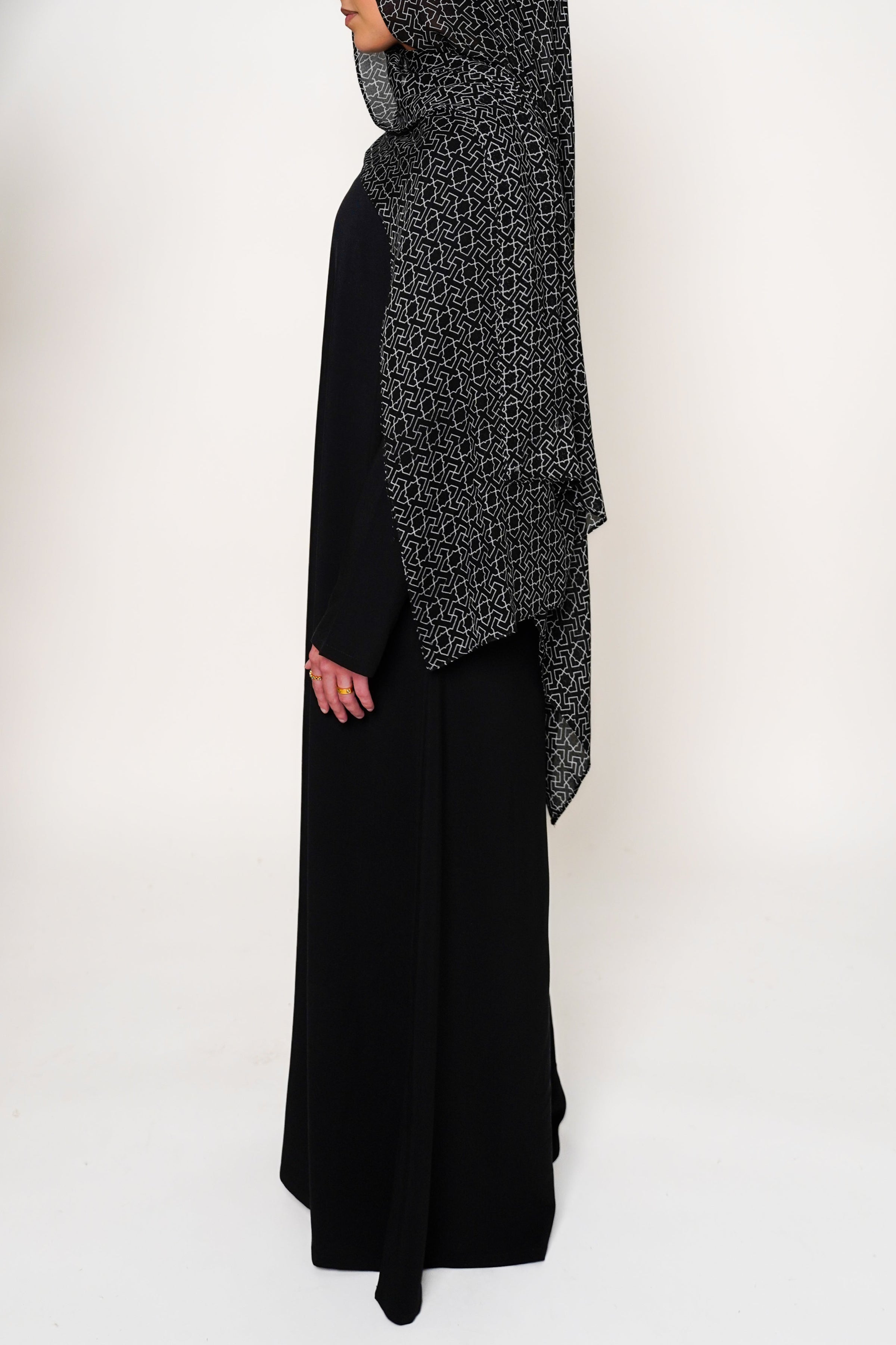 Geo Black Bamboo Modal Hijab in black featuring a modern geometric pattern in white, offering a sleek and stylish design that blends elegance with contemporary appeal.