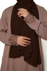 Heather Sand Button Back Embroidered Abaya Close-up of the brown abaya featuring intricate embroidery on the sleeves, showcasing its sophisticated design. This timeless piece combines elegance and comfort, perfect for both dinner parties and masjid visits