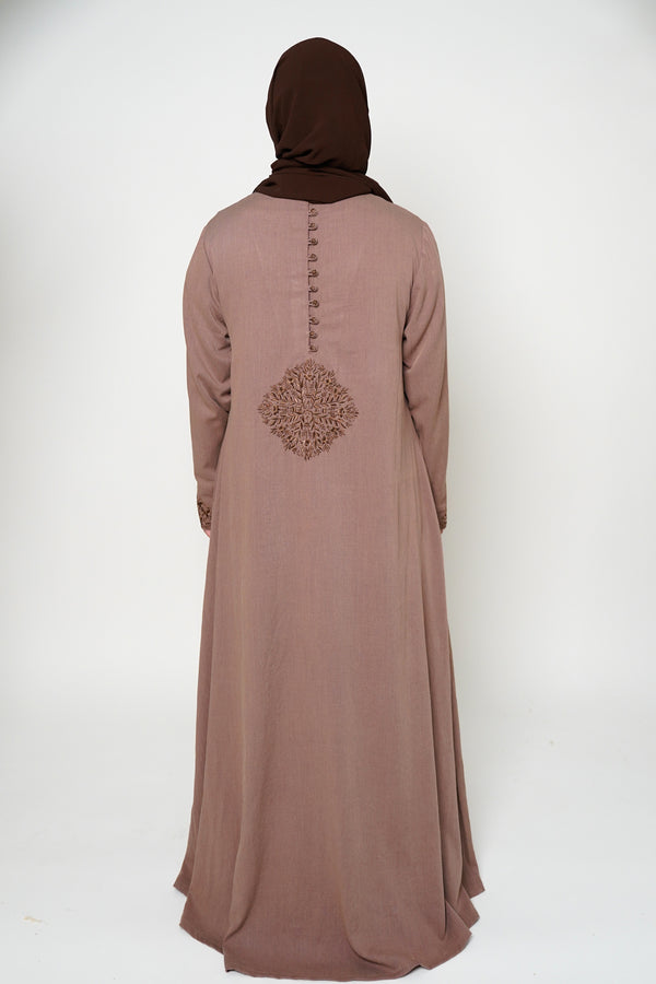 Back view of a brown abaya with intricate embroidery on the buttons, back, and sleeve ends, offering sophistication and exclusivity. A timeless piece perfect for both dinner parties and masjid visits, combining style and comfort.