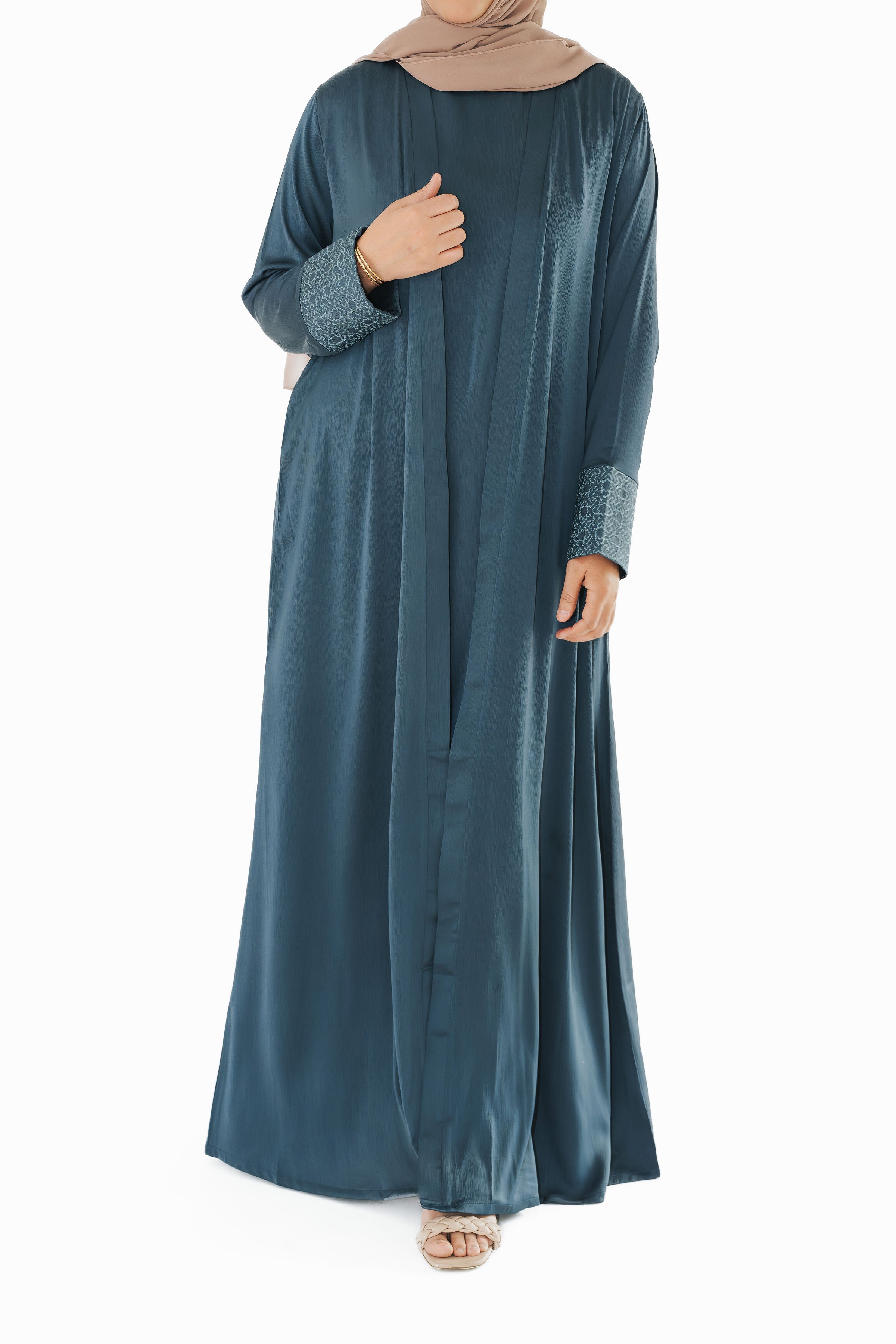 Slate blue open abaya with geometric embroidered cuffs, offering a sophisticated and exclusive design that elevates modest style
