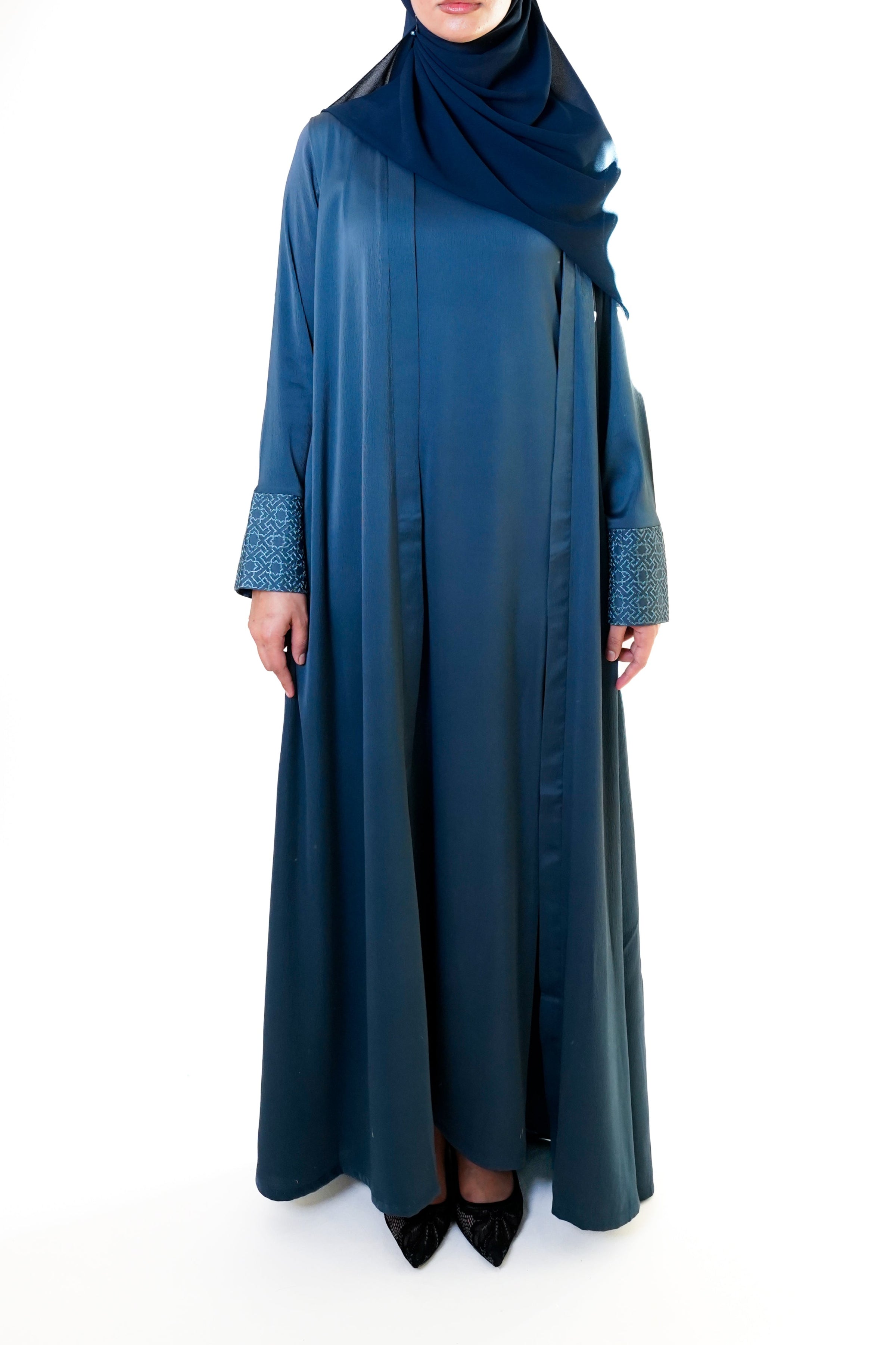 Slate blue open abaya with geometric embroidered cuffs, offering a sophisticated and exclusive design that elevates modest style