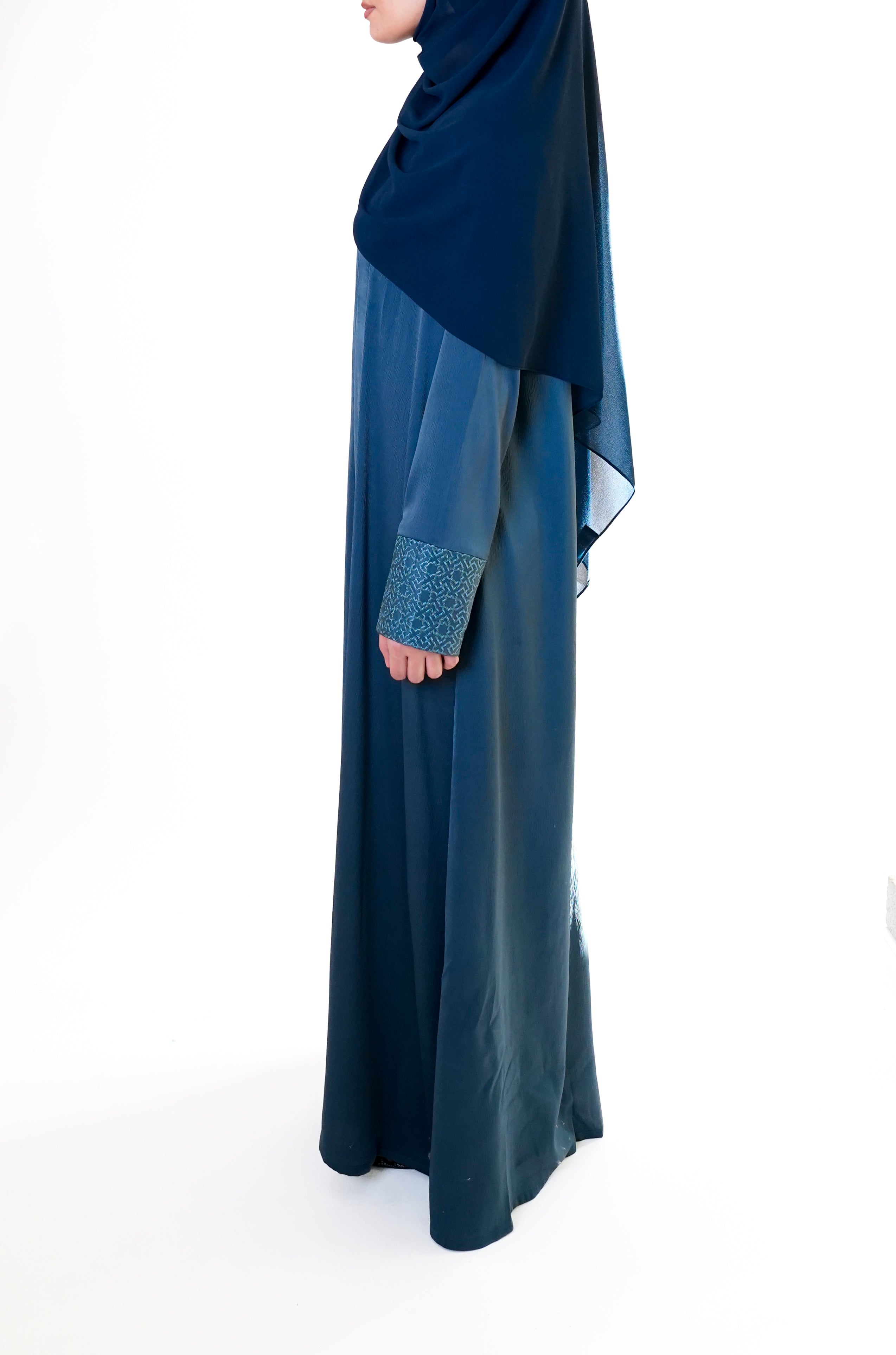 Slate blue open abaya with geometric embroidered cuffs, offering a sophisticated and exclusive design that elevates modest style