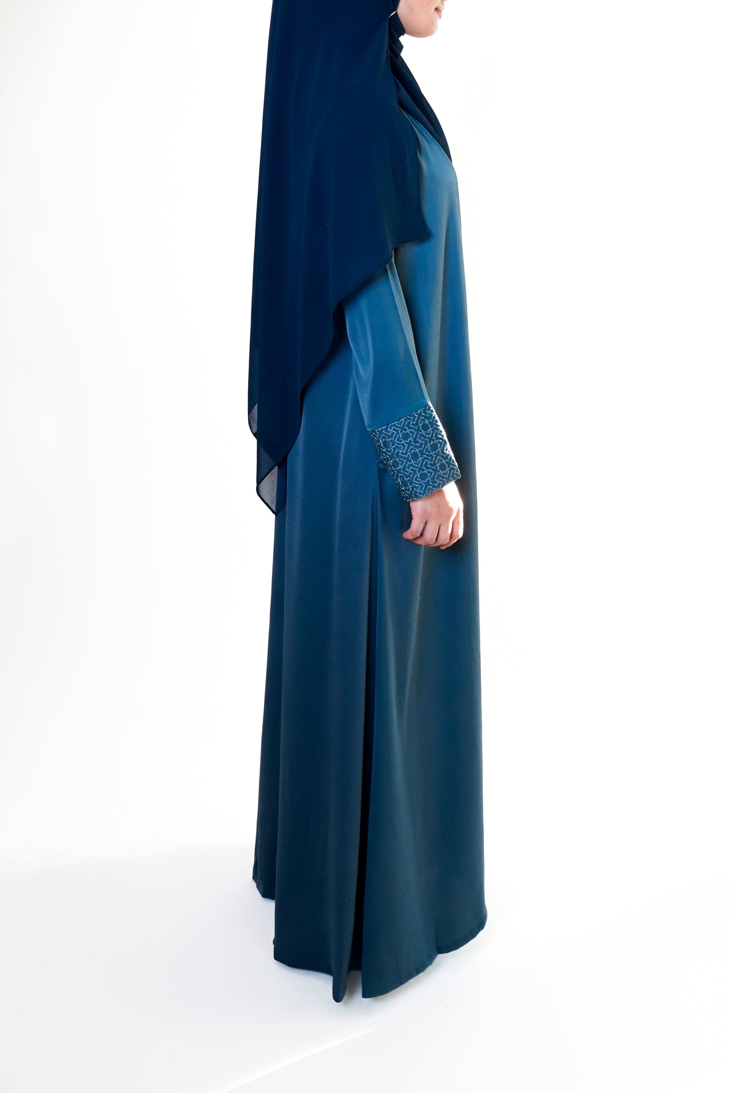 Slate blue open abaya with geometric embroidered cuffs, offering a sophisticated and exclusive design that elevates modest style